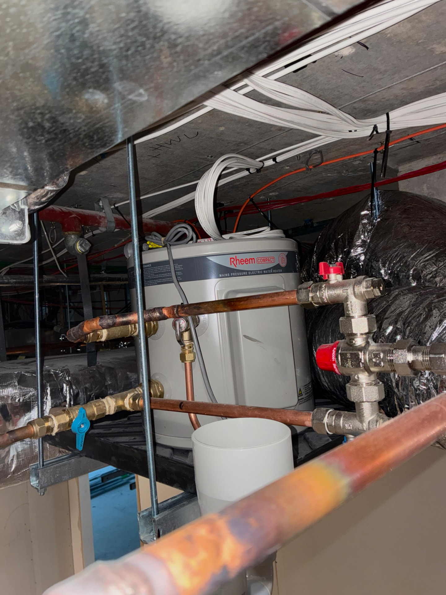 Rheem compact electric hot water system installed in a plant room